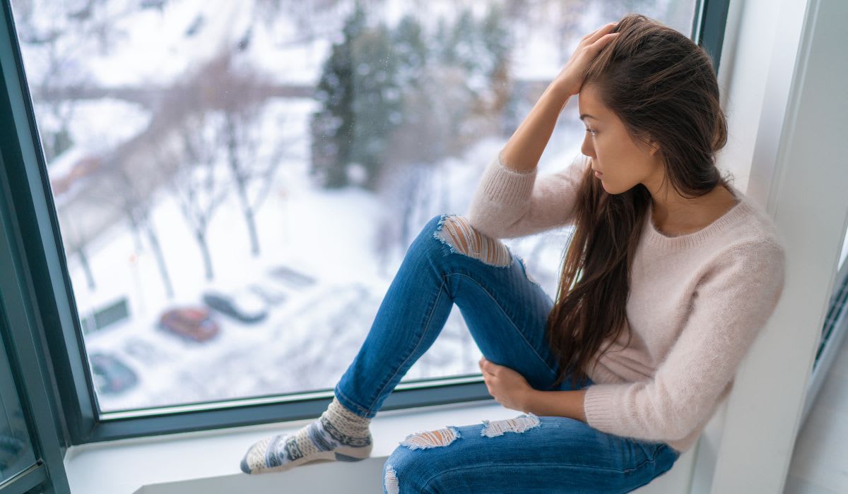 sad woman looking out the window